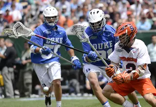 Kevin Rice races two Duke players for a loose ball. Rice finished with one goal and three assists.