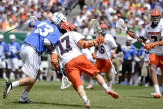 Dylan Donahue shields Duke's Chris Hipps with his left shoulder while dodging. Donahue tallied three goals and one assist.