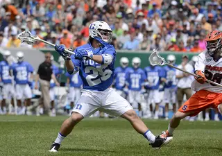 Duke's Josh Offit rips a shot past the outstretched stick of Peter Macartney.