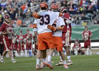 Scott Loy jumps into a celebratory hug. His goal with 8:17 remaining brought SU to within one.