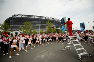 Syracuse cheerleaders and members of the marching band perform outside MetLife Stadium in East Rutherford, N.J. 