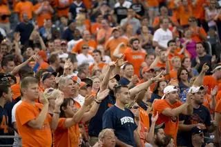 Cheering Syracuse fans encircle a melancholy Penn State fan in the second half. 