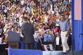 Hundreds of spectators cheer as President Barack Obama walks onto the stage inside Henninger High School.