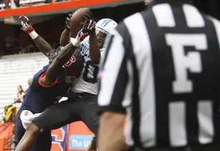 Tulane wide receiver Justyn Shackleford leaps over top the Syracuse defense to haul in a touchdown.