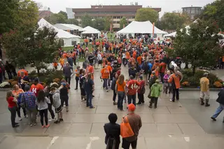 Members of the Syracuse community convene on the quad for various homecoming activities.