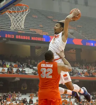 Michael Gbinije takes a little help from DaJuan Coleman en route to his slam-dunk contest victory.