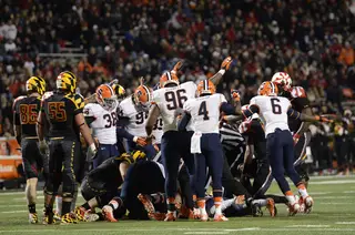 Syracuse players all signal that the ball is theirs after a fumble. 