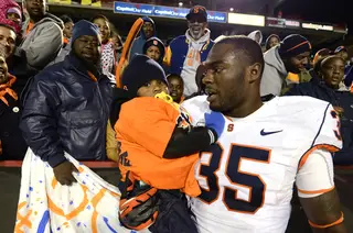 Dyshawn Davis celebrates with family after Syracuse's 17-point win. 
