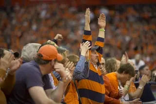 A Syracuse fan celebrates a Syracuse 3-pointer. Despite the inclement weather a large, loud crowd showed up to the Carrier Dome. 