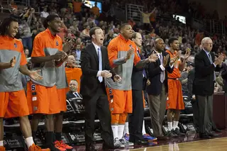 The Orange bench, led by assistant coach Gerry McNamara (center), energizes the team. 