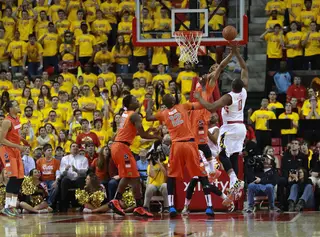 Gbinije and Terrapins forward Charles Mitchell fight for a loose ball in the middle of the paint. 