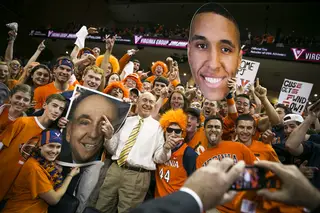 ESPN announcer Dick Vitale poses for a picture with members of University of Virginia’s student section. 