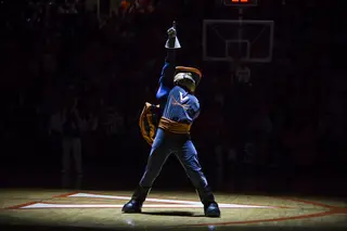The Virginia mascot invigorates the sold-out crowd in a spotlight prior to the game. 