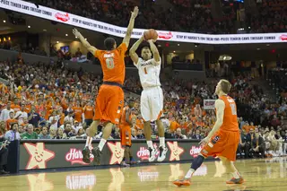 Virginia guard Justin Anderson fires a jump shot over an outstretched Michael Gbinije. 