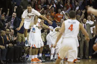 Justin Anderson leaps in celebration in front of the Virginia bench as the Cavaliers' Atlantic Coast Conference regular-season crown is sealed. 