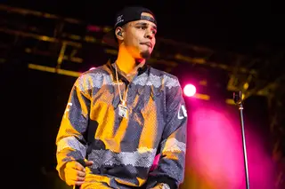 J.Cole pauses during his initial arrival on stage in the Carrier Dome on March 21, 2014.