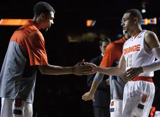Ennis and Michael Gbinije exchange a handshake prior to tipoff. 
