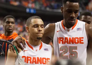 Christmas (right) consoles Ennis (left) after Syracuse's loss. 