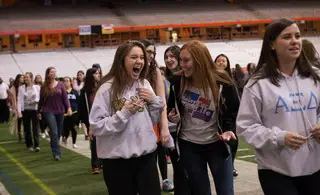 Students walk around the Carrier Dome as a part of Relay for Life. 