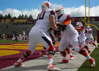 Sean Hickey (60) and a fellow offensive lineman warm up before the start of Syracuse's matchup with Central Michigan.