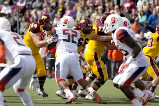 Syracuse nose tackle Eric Crume (52) looks to apply pressure on CMU.