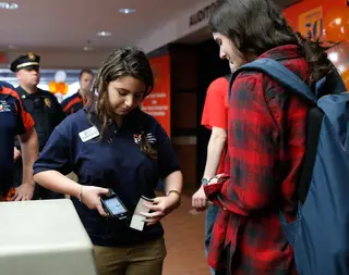 Daniella Rasho, a sophomore in the bandier program, gets her ticket scanned as she enters the reception for the Newhouse studio dedication.