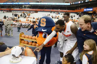 Otto the Orange, Christmas and SU assistant coach Mike Hopkins cheer on contestants during the pie-eating contest. 