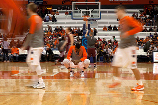 Rakeem Christmas squats at mid-court before Syracuse's matchup with Colgate.