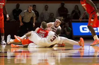 Cooney fights for a loose ball with Hokies Will Johnston and Adam Smith.