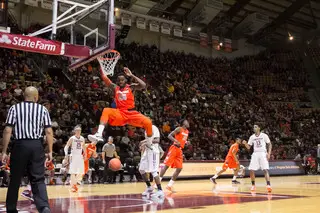 Christmas finishes off a dunk as three Hokies defenders stand and watch.