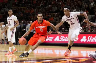 Michael Gbinije drives right against VT forward Shane Henry in the second half.