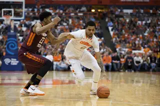 Michael Gbinije uses his left hand to drive to the hoop against VT's Jalen Hudson. Gbinije stroked in a game-winning bucket with one-tenth of a second left on the clock.