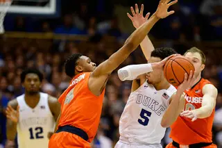 Duke's Tyus Jones looks for a opening around Syracuse's defense, but is blocked by Patterson, left, and Cooney, right.