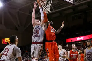 Christmas and Clifford contend for the ball near the rim. The SU forward was held to seven points, his lowest total of the season.