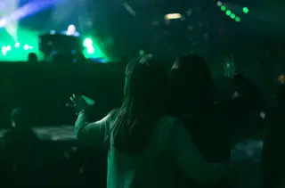Two women in the crowd dance and enjoy Joel's performance.