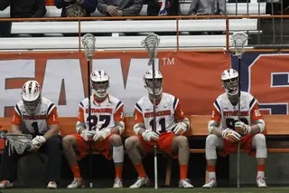 (From left to right) Syracuse's Bobby Wardwell, Sean Young, Brandon Mullins and Jay McDermott watch from the sideline.