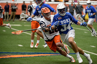 Syracuse long-stick midfielder Peter Macartney bodies up Duke's Pat Resch. Macartney defended star midfielder Myles Jones for the most part, limiting him to one point.