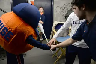 Otto the Orange — with Kurkjian inside the suit — Pregler and Fenton get together before the men's basketball game Monday night. Fenton prompted the team with, “Are we ready team?” The rest respond, “Lots of pulp.” 