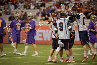 Syracuse celebrates after scoring against the Great Danes. The Orange rattled off 45 shots in its eighth win of the season.