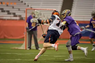 Syracuse midfielder Henry Schoonmaker runs against a Great Danes defender. The SU senior scored a career-high five goals in the game.
