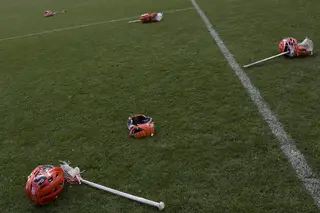 SU helmets, sticks and gloves lie on the PPL Park grass.