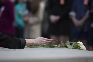 Scholars placed white roses on the Remembrance Wall to honor the lives that were lost.