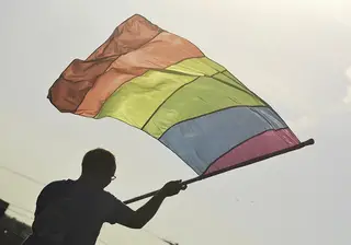 Rainbow flags wave as a LGBT choir performs at the New York State Fair.