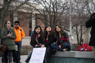 Three SU students sit together. All three spoke at the rally, calling for unity against aggressive immigration enforcement tactics.
