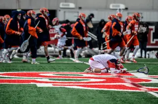 SJU's TJ Marron stays in disappointment as Syracuse celebrates the win. 