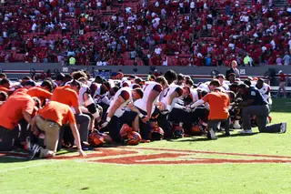 The Orange all took a knee on the field after
 the game. 