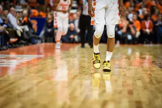 Battle sporting his yellow shoes as he walks along the court.