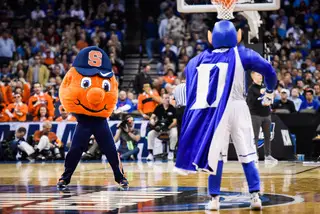 The team mascots dance at center court. 