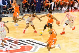 Syracuse and Ohio State players go after a loose ball.
