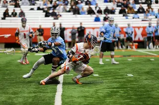 Griffin Cook dodges a Johns Hopkins player near the midfield.